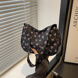 Chic black hobo bag with pink bow patterns and quilted bubble texture fabric
