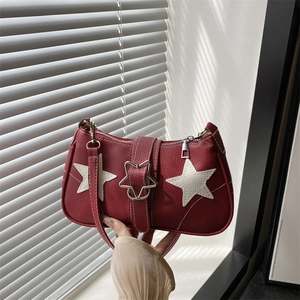 Chic burgundy star-patterned handbag with faux leather texture and metallic star clasp