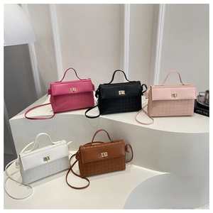 Close-up of five colorful square handbags with gold twist locks and embossed texture details