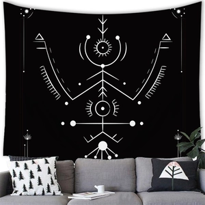 Detail of modern black and white bohemian tapestry with tribal patterns on a living room wall