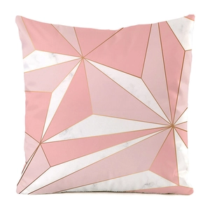 Macro detail of geometric patterns with pink tones and gold lines on faux silk cushion