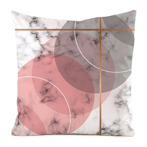 Close-up of geometric marble cushion cover with pink circles and golden line details