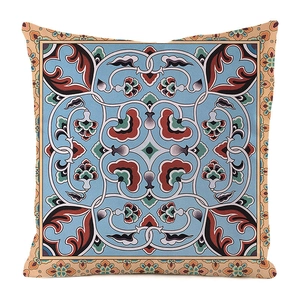 Macro detail of geometric floral faux silk cushion cover with blue Persian patterns