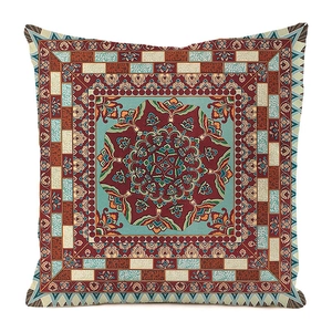 Macro shot of mandala pattern sofa cushion cover with red floral embroidery detail