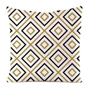 Detail of square pillowcase featuring geometric diamond pattern in black and gold silk fabric