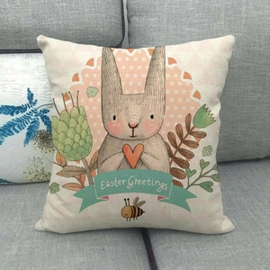Easter rabbit linen throw pillow cover with Easter Greetings text on a sofa