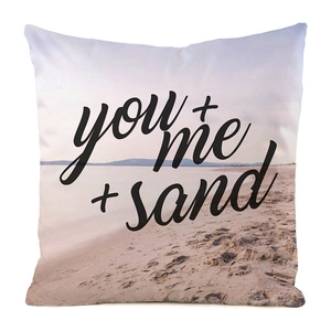 Detail of square pillowcase with seaside beach print and you + me + sand text