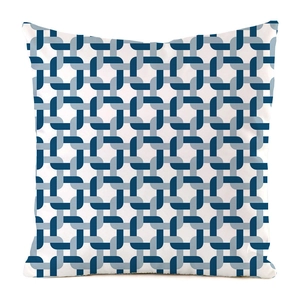 Detailed close-up of geometric chain link pattern on a white silk-like cushion cover