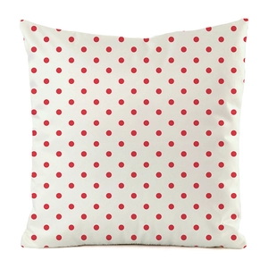 Close-up of square cushion cover with red polka dots on a cream white background