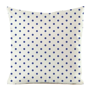 Detail shot of the cream-colored square cushion with deep blue polka dot patterns