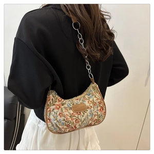 Detail of floral nylon shoulder bag with leather trim and gold chain strap