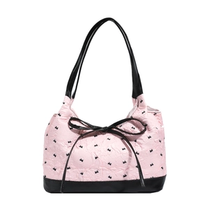 Pink embossed shoulder bag featuring a black bow and chic Playboy-style pattern print