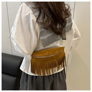 Detail of brown suede tassel crossbody bag with ethnic style embroidered shoulder strap