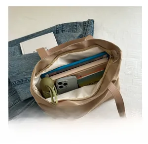 Internal view of beige nylon tote bag showing large capacity for tablet and daily items