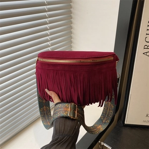 Burgundy suede fringe crossbody bag with bohemian patterned strap and gold hardware