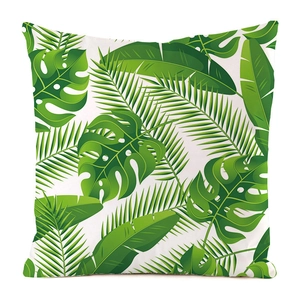 Detail of faux silk cushion cover featuring green tropical leaves and palm leaf pattern