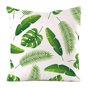 Detail of square satin pillowcase with green tropical leaf patterns and smooth texture