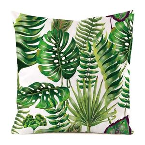 Detail of tropical monstera leaf print on white faux silk square cushion cover