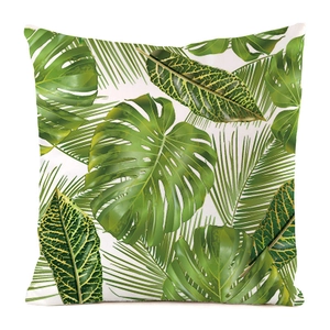 Detail of tropical monstera leaf print on a square decorative faux silk cushion cover