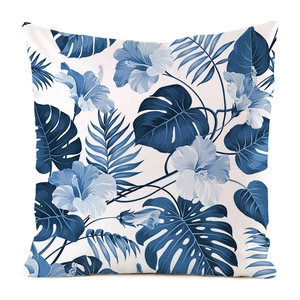 Detail of square pillowcase with tropical blue hibiscus and palm leaf patterns