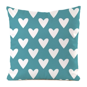 Close-up of cyan faux silk cushion cover featuring white heart patterns for home decor