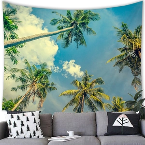 Detailed close-up of a tropical palm tree tapestry hanging above a grey sofa set