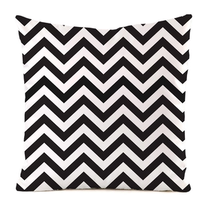 Close-up of square cushion cover with black and white wavy geometric patterns
