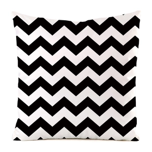 Detail shot of square throw pillow cover featuring bold black and white chevron patterns