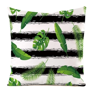 Detail of tropical monstera palm leaf print on striped faux silk pillowcase fabric
