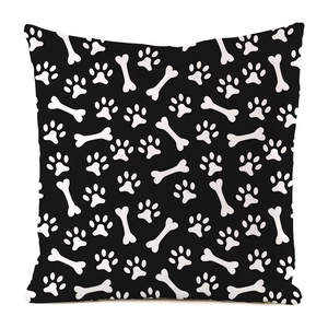 Detail view of square black pillowcase with white bone and pet paw print patterns