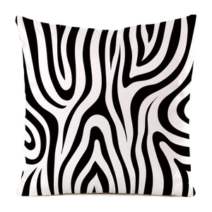 Detail of square cushion cover with modern black and white zebra pattern on silk-like fabric