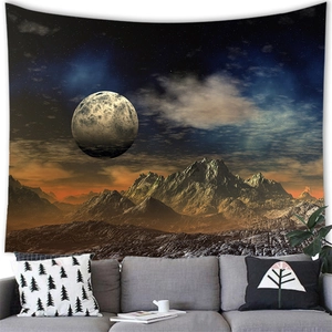 Detailed view of sunset mountain and moon tapestry hanging above a modern living room sofa