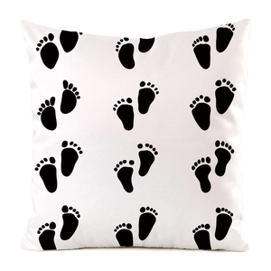 Close-up of faux silk pillowcase showing smooth satin texture and black footprint pattern