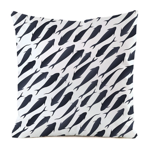 Close-up of faux silk pillow cover featuring navy fish silhouette patterns on white canvas