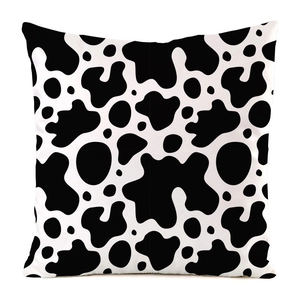Detailed view of the soft faux silk fabric and black and white cow print pattern on the pillowcase