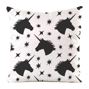 Close-up of black unicorn silhouettes and stars pattern on faux silk square pillow cover