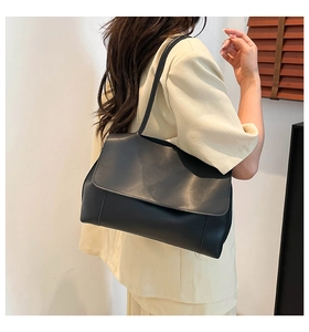 Minimalist black matte leather oversized shoulder bag with wide flap and long strap