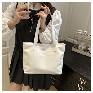 Mirror selfie showing the large capacity minimalist white tote bag with long straps