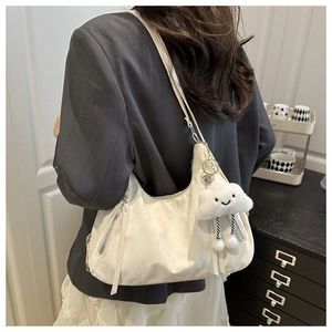 Detail of off-white nylon hobo bag with zip pocket and cute white cloud plush charm