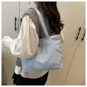 Light blue tote bag side view showing spacious capacity and wide shoulder strap