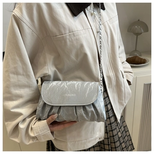 Detail showing the pleated silver texture and fashion print on the crossbody chain bag