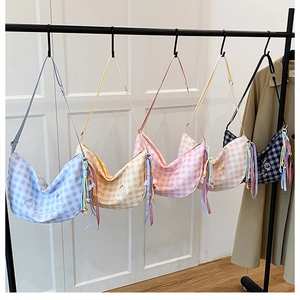 Detailed view of checkered crescent bags in five colors with embroidery and beaded charms