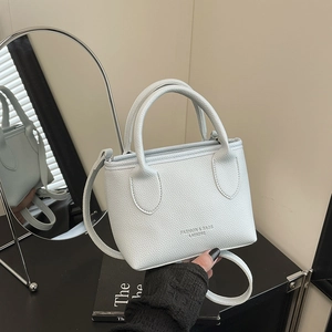 Mint green lychee pattern faux leather bucket bag with top handles and shoulder strap