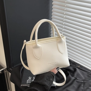 Off-white lychee texture leather mini bucket bag with top handle and crossbody strap