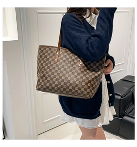 Close-up of brown checkered leather tote bag with stylish Z pattern and gold hardware