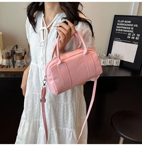 Pink Boston bag with KS&KS embossed letters and adjustable shoulder strap detail