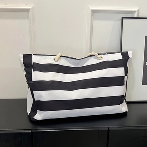 Black and white striped canvas tote bag with cotton rope handles for beach and travel