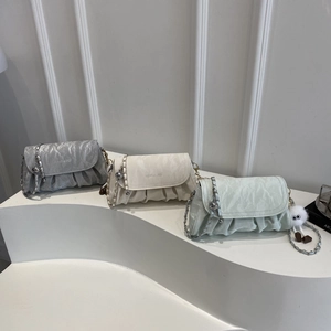 Three pleated crossbody bags in silver, cream and mint green with chic chain straps