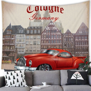 Detail view of Cologne Germany tapestry with vintage red car hanging above a grey sofa