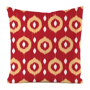 Detail of red faux silk cushion cover featuring ethnic ikat circle patterns and rich texture